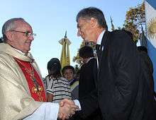 Macri shaking hands with Archbishop Jorge Bergoglio (now Pope Francis)