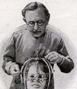 Max Factor Sr. in 1935, demonstrating his beauty micrometer device.