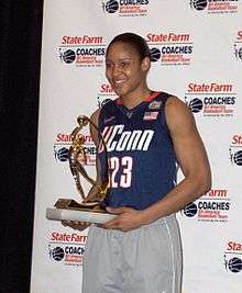 Maya Moore holding a gold-plated trophy in 2011