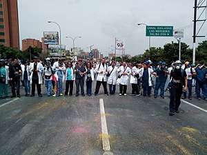 Line of doctors blocking a street