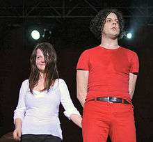 Jack White and Meg White standing together onstage.