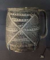 A color picture of a black-on-white pottery vessel
