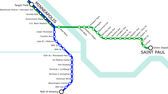 A simple transit diagram with a green line stretching roughly left to right (west to east) and a blue line stretching roughly top to bottom (north to south). A light blue river runs from the top right to the bottom right, roughly following the shape of a ladle. Another thinner waterway runs straight from center-left to connect with the river near the center of the image.