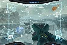 A video game screenshot. A weapon points outwards towards a snowy landscape.