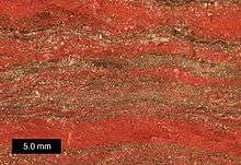 This photograph is a close-up shot of a banded-iron formation specimen from Michigan's Upper Peninsula.