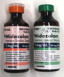 Two 10-ml bottles labeled Midazolam. The bottle on the left has a label in red and says 1 mg/ml; the one on the right is in green and says 5 mg/ml. Both bottles have much fine print.