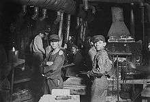 Child laborers in a glass works circa early 1900s