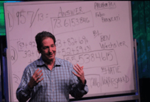 Mike Byster standing in front of a whiteboard during a TEDx presentation in Naperville, IL.