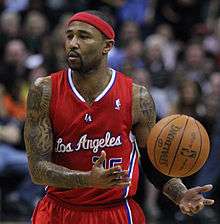 Mo Williams playing for the Los Angeles Clippers while on the road in a red uniform.