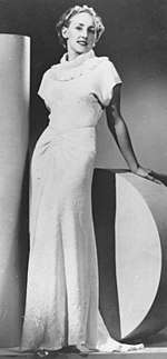 Model posing in a glamorous 1930s evening gown.