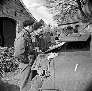 Major General Christopher Vokes in discussion with Brigadier Robert Moncel standing in a street in Sögel on 10 April 1945