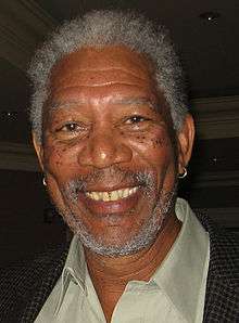 Morgan Freeman  facing the camera and smiling