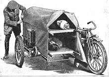 Securing the canvas cover on a motorcycle sidecar containing two patients
