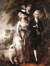 "A man and a woman walking next to a wood with their white dog. The woman is dressed in a white 18th-century gown and a black hat, and the man is dressed in a black suit with white stockings."