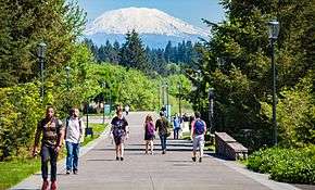 Mt. St. Helens as seen from WSU Vancouver with students walking on campus path in foreground.