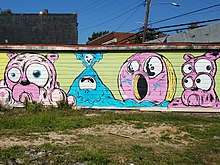 Mural by Ray Geier in East Atlanta featuring a doughnut and French Bulldogs
