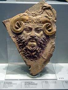 Greco-Roman-style sculpture of the face of a man with a beard and ram's horns