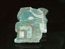 Fragmentary relief of green glaze showing a woman seated.
