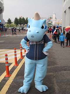 Dinos mascot, Dandi, poses in front of the Masan Baseball Stadium.