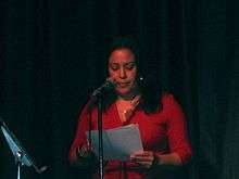 Poet on stage reading work