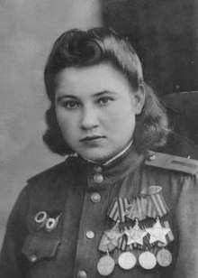 Photograph of Necheporchukova wearing her medals, including her three Orders of Glory