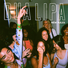 A picture of a group of women partying in a white room, with the name of the singer and the title of the song superimposed over them in capital letters.