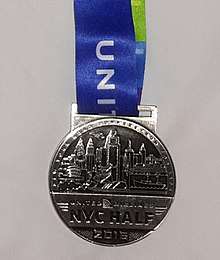 The official 2016 New York Half Marathon finisher medal.