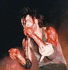A photo of Nivek Ogre performing with Skinny Puppy in 1987.