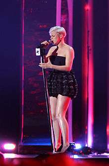 Robyn onstage in a short black dress