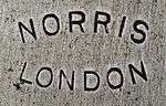 Norris, London in sans serif letter in an ellipse