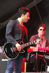 Adam Zindani playing guitar and in the background Tony Kirkham playing keyboards