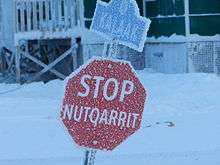 Octagonal stop sign reading STOP / NUTQARRIT