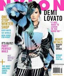 Nylon magazine cover, featuring Demi Lovato with blue hair in faux-fur.