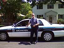 An ACPD policeman in front of his cruiser in 2012.
