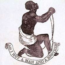 Drawing which shows a slave kneeling and holding up his clasped and manacled hands. Underneath him, a banner says "Am I Not a Man and a Brother?"