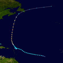Track of a tropical cyclone, with different colors corresponding to differing intensities. The track begins to the right, moves left and then up, eventually crossing a land mass near the top of the image.