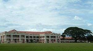 Part of the Malay College Kuala Kangsar buildings with its football field in the foreground.