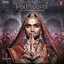 A woman dressed in Rajasthani finery, decked up with heavy traditional jewellery, wearing a small bindi, sporting a unibrow and she is joining hands. On the top of her image is the title of the soundtrack album whereas the composer credits are below.