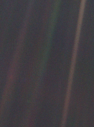 Dark grey and black static with coloured vertical rays of sunlight over part of the image. A small pale blue point of light is barely visible.