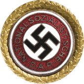 a circular golden badge with a central swastika