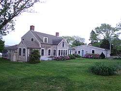 This is a large farmhouse that with a sun room and greenhouse in the back.
