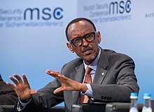 Kagame speaking, seated at a panel