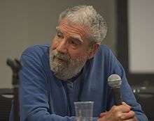 Photograph of Peter Nicholls sitting during a panel discussion