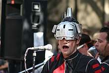 Joebot wearing a silver helmet.