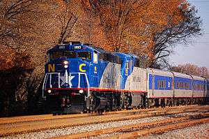 Blue and gray train with fall foliage