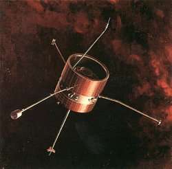 A barrel-like space probe with several antennae floats through red-black space.