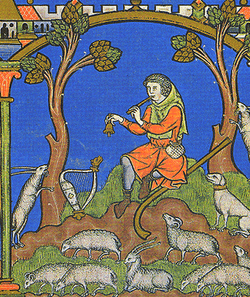 A painting showing a man in orange clothes playing a pipe and ringing a small bell. He is surrounded by numerous small white sheep, and two trees sit on either side of him. A small village is depicted in the upper left hand corner.