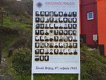 Outdoor board with many photos of priests
