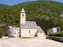 Simple white church on a hillside