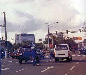 A picture of the Port Harcourt City centre from a highway with traffic and high rises in the distance